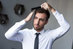 man combing hair deposit photo Feb 2020