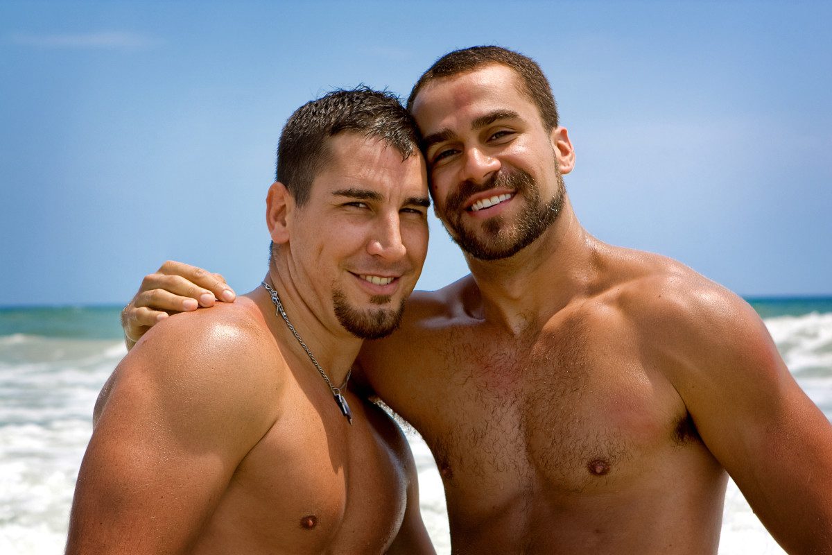 gay male couple on beach. 