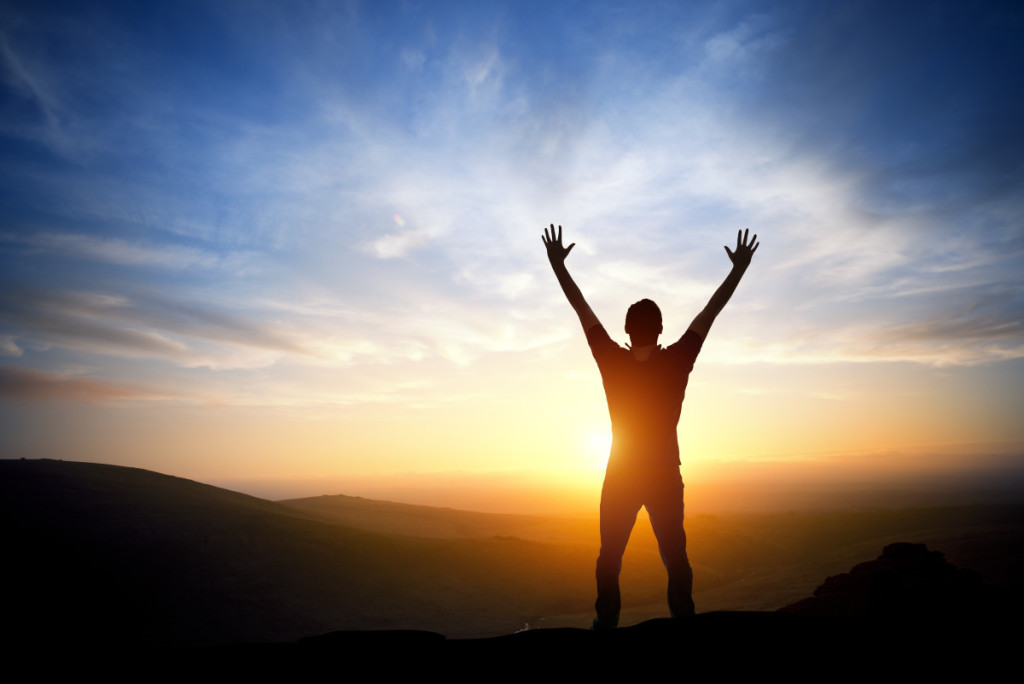 kh pp man standing on rocks at sunrise home page dollar photo