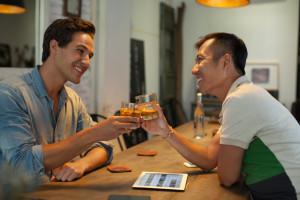 Two Men Cheers Toast Drink Ice Coffee, Asian Mix Race Friends Guys Happy Smile Sitting at Cafe Natural Light