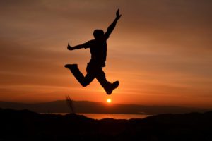 gay man jumping at sunset resilience article 2