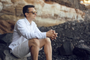 single gay man on beach with sunglasses deposit photo May 2020
