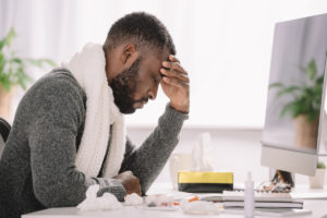stressed black man at computer deposit photo June 2020
