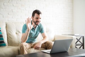 Man video chatting with his partner over the computer.