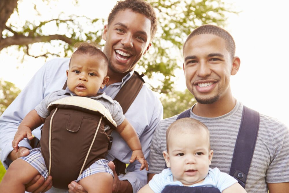 depositphotos 64582431 stock photo two fathers with babies e1605214578484