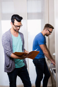gay couple standing discussing with file deposit photo 11 12 20
