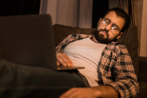 tired man with glasses asleep with laptop deposit photo 11 24 20