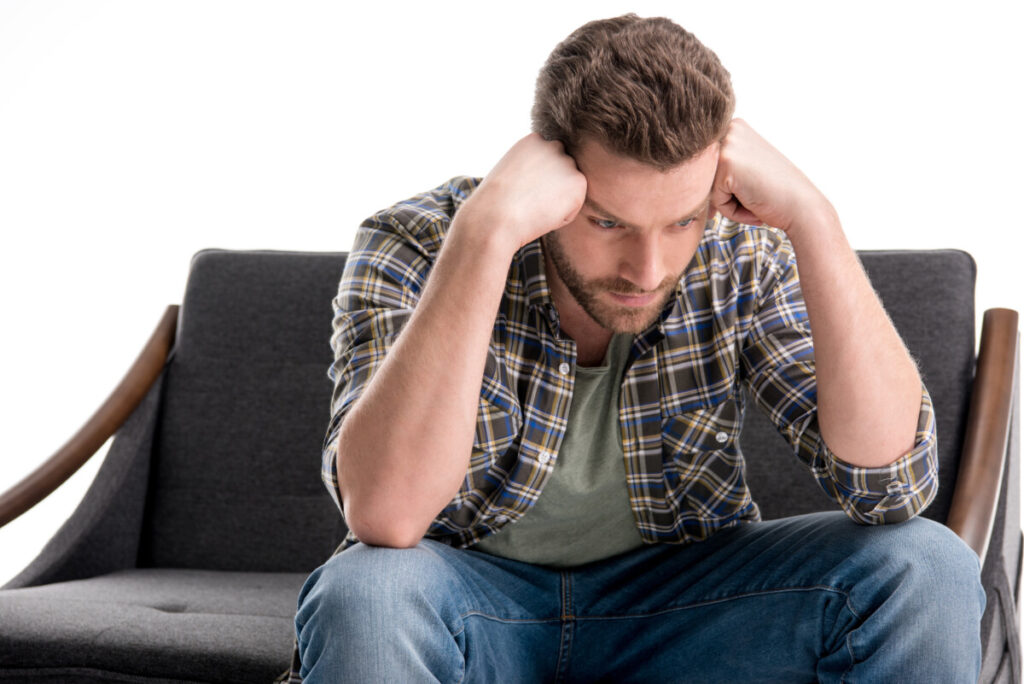 sad man with head resting on fists deposit photo November 2021 1