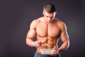bodybuilder shirtless eating his meal prep deposit photo 12 29 21
