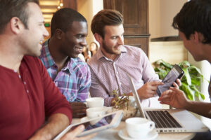 friends male 4 meeting in a restaurant watching a screen deposit photo December 2021