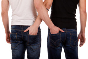 men with hands in each others jeans pockets deposit photo December 2021