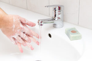 hands under a faucet soapy deposit photo January 2022