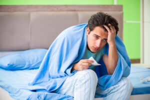 sick man under blue blanket deposit photo 2 6 22