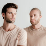 two men in beige t shirts lower volume file Feb 2022