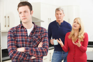 man annoyed with parents in background deposit photo 3 29 22