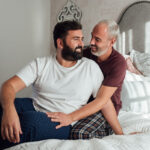 gay couple in bed one dark hair one gray hair deposit photo 4 11 22