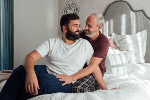 gay couple in bed one dark hair one gray hair deposit photo 4 11 22