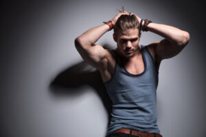 man with arms up tying hair tank top pits 4 11 22