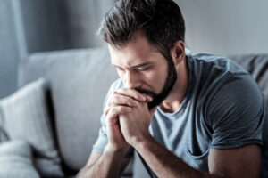 man with beard praying blue shirt deposit photo 5 19 22