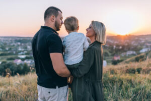 straight couple with little boy at sunset deposit photo 5 19 22