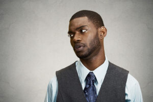 annoyed angry Black man in gray vest deposit photo 8 7 22