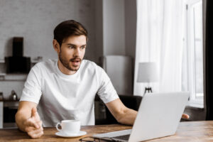 surprised man looking at laptop white t shirt deposit photo 8 7 22