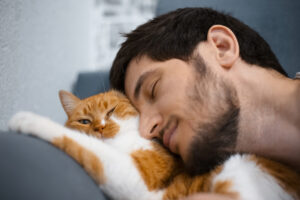 man snuggling with orange cat deposit photo 9 28 22