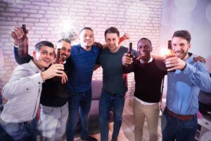 group of six men with beer bottles at party deposit photos March 2023