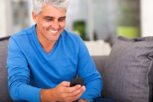 middle aged man on cell phone texting