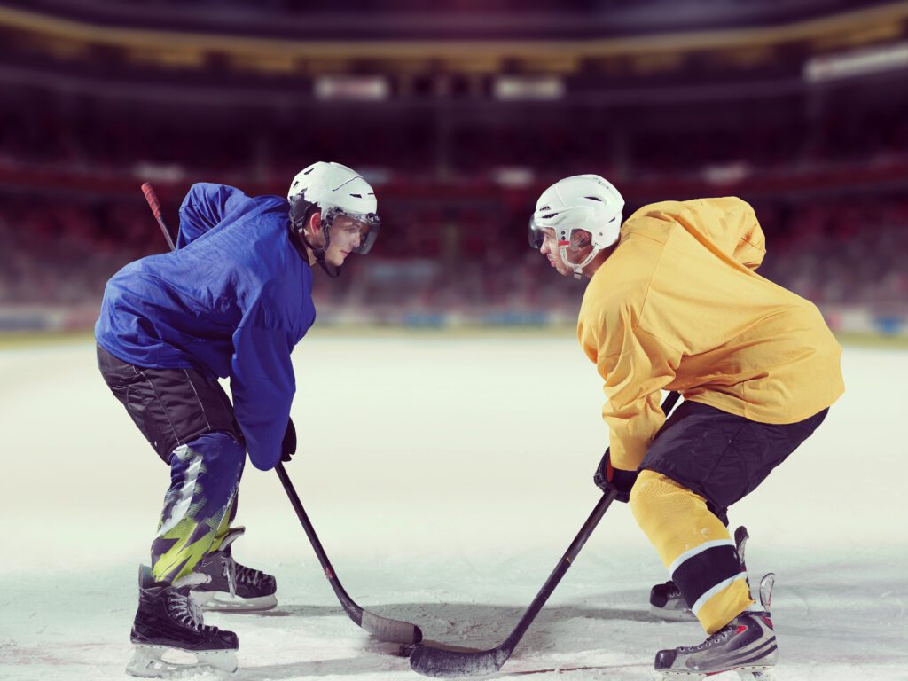 two hockey players facing off